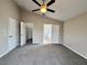 Spacious main bedroom features carpeted floors, ceiling fan, ensuite access, and a walk-in closet at 3049 Buckeye Pointe Dr, Winter Haven, FL 33881
