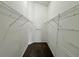 Walk-in closet offers ample storage space with built-in shelving and carpeted floors at 3049 Buckeye Pointe Dr, Winter Haven, FL 33881