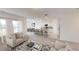 Spacious living room with modern furnishings and a large kitchen island perfect for entertaining at 3251 Nightfall Rd, Winter Haven, FL 33881