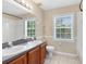 Well-lit bathroom featuring double sinks, tiled floors, and a shower/tub combination with large windows at 3813 Goldenglow Dr, Orlando, FL 32828