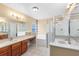 Bathroom featuring a soaking tub, separate shower, dual vanity sinks and tiled floors at 3813 Goldenglow Dr, Orlando, FL 32828