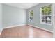 Bright bedroom with hardwood floors, two windows offering ample natural light and neutral wall paint at 3813 Goldenglow Dr, Orlando, FL 32828