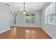 Well-lit dining room with light blue walls, wood floors, and bright windows creating a welcoming atmosphere at 3813 Goldenglow Dr, Orlando, FL 32828