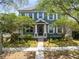 Charming two-story home featuring a beautifully landscaped front yard with mature trees and inviting walkway at 3813 Goldenglow Dr, Orlando, FL 32828