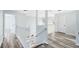 Bright hallway with wood-look floors, white railing, and lots of natural light at 3813 Goldenglow Dr, Orlando, FL 32828