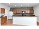 Bright kitchen with stone backsplash, stainless steel appliances, and white breakfast bar, great for Gathering meals at 3813 Goldenglow Dr, Orlando, FL 32828