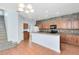 Open kitchen with tile floors, a breakfast bar, stone backsplash and wood cabinets, perfect for casual dining at 3813 Goldenglow Dr, Orlando, FL 32828