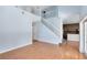 Bright, open-concept living room featuring wood floors and a staircase leading to a second-floor balcony at 3813 Goldenglow Dr, Orlando, FL 32828