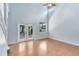 Bright living room with soaring ceilings, laminate floors, and French doors to the patio for indoor/outdoor living at 3813 Goldenglow Dr, Orlando, FL 32828