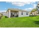 Expansive backyard with lush green grass and a covered patio, perfect for outdoor entertaining at 439 Shoreview Sands Ave, Mascotte, FL 34753