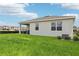 Spacious backyard with healthy grass and a covered patio, ideal for outdoor activities at 439 Shoreview Sands Ave, Mascotte, FL 34753