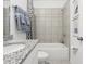 Bathroom featuring a sink with granite countertop, white cabinets, and a shower with a tile surround at 439 Shoreview Sands Ave, Mascotte, FL 34753