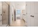 Bright bathroom featuring a tiled shower with a glass door, vanity, and view to the main bedroom at 439 Shoreview Sands Ave, Mascotte, FL 34753