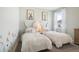 Bright bedroom with matching twin beds, cute decor, and a window letting in plenty of natural light at 439 Shoreview Sands Ave, Mascotte, FL 34753