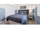 Comfortable bedroom with blue color scheme, a window, and closet, perfect for relaxation and storage at 439 Shoreview Sands Ave, Mascotte, FL 34753