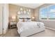Cozy bedroom featuring a queen-sized bed, decorative wall accents, and a large window at 439 Shoreview Sands Ave, Mascotte, FL 34753