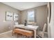 Cozy dining room with a stylish table, seating bench, neutral decor, and natural light from the window at 439 Shoreview Sands Ave, Mascotte, FL 34753