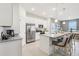 Bright kitchen with stainless steel appliances, granite countertops, and an adjacent dining area at 439 Shoreview Sands Ave, Mascotte, FL 34753