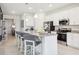 Bright kitchen featuring granite countertops, a stainless steel oven, and white cabinetry at 439 Shoreview Sands Ave, Mascotte, FL 34753