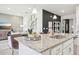 Modern kitchen with granite countertops, stainless steel appliances, and a view into the living area at 439 Shoreview Sands Ave, Mascotte, FL 34753