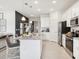 Open kitchen showcasing granite countertops, stainless steel appliances, and stylish gray barstools at 439 Shoreview Sands Ave, Mascotte, FL 34753