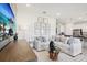 Bright living room showcasing a comfortable sofa, modern coffee table, stylish wall art, and open floorplan at 439 Shoreview Sands Ave, Mascotte, FL 34753