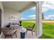 Inviting covered patio with seating area overlooking the landscaped backyard and green space at 439 Shoreview Sands Ave, Mascotte, FL 34753