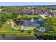 Aerial view of condos surrounding beautiful lake with fountain and walking path at 4400 Thornbriar Ln # 104, Orlando, FL 32822