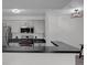 Well-equipped kitchen with modern appliances and breakfast bar overlooking living area at 4400 Thornbriar Ln # 104, Orlando, FL 32822