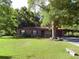 Charming brick home with mature trees and well-manicured lawn at 4519 Se 140Th Pl, Summerfield, FL 34491