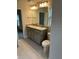 Bathroom featuring double vanity, granite countertops, and a large framed mirror at 4586 Se 25Th Loop, Ocala, FL 34480