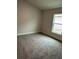 Bright bedroom with neutral-toned walls and soft carpeting, offering a comfortable and inviting space at 4586 Se 25Th Loop, Ocala, FL 34480