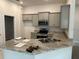 Kitchen with granite countertops, stainless steel appliances, and gray cabinets at 4586 Se 25Th Loop, Ocala, FL 34480