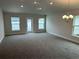 Spacious living room featuring plush carpeting, recessed lighting, and multiple windows with backyard views at 4586 Se 25Th Loop, Ocala, FL 34480