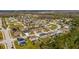 Aerial view of the property within a neighborhood featuring tree-lined streets and community pond at 4905 Pall Mall E St, Kissimmee, FL 34758