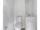 Clean half-bathroom with modern vanity, sink, toilet, mirror, and hardware at 4905 Pall Mall E St, Kissimmee, FL 34758