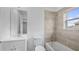 Neutral bathroom features tub, shower with tan tile surround and a white vanity at 4905 Pall Mall E St, Kissimmee, FL 34758