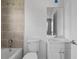 Clean bathroom features tub, shower with tan tile surround and a white vanity at 4905 Pall Mall E St, Kissimmee, FL 34758