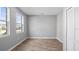 Empty bedroom featuring modern vinyl floors, a large window, and white walls at 4905 Pall Mall E St, Kissimmee, FL 34758