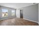 Well-lit bedroom with wood-look flooring, neutral walls, and large windows offering plenty of natural light at 4905 Pall Mall E St, Kissimmee, FL 34758