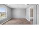 Simple bedroom has laminate floors, neutral walls, and a large window with natural light and bathroom access at 4905 Pall Mall E St, Kissimmee, FL 34758