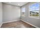 Sunlit bedroom featuring two windows and modern flooring, offering a bright and airy space at 4905 Pall Mall E St, Kissimmee, FL 34758