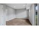 Empty bedroom featuring modern vinyl floors, a large window, and white walls at 4905 Pall Mall E St, Kissimmee, FL 34758