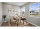 Cozy dining area with modern table setup and ample natural light streaming in from large windows at 4905 Pall Mall E St, Kissimmee, FL 34758
