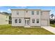 Two-story home boasts a symmetrical design with a well-manicured lawn and attached one-car garage at 4905 Pall Mall E St, Kissimmee, FL 34758