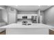 Modern kitchen featuring a large island with a sink, stainless steel appliances, and white cabinetry at 4905 Pall Mall E St, Kissimmee, FL 34758