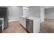 Bright kitchen features white cabinets, stainless steel appliances, quartz countertops, and wood-look floors at 4905 Pall Mall E St, Kissimmee, FL 34758