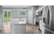 Open kitchen with an island, stainless steel appliances, and access to the backyard through sliding doors at 4905 Pall Mall E St, Kissimmee, FL 34758