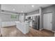 Spacious kitchen featuring white cabinets, stainless steel appliances, and a large island at 4905 Pall Mall E St, Kissimmee, FL 34758