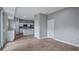 Spacious living room with wood-look floors and neutral walls that open to kitchen at 4905 Pall Mall E St, Kissimmee, FL 34758
